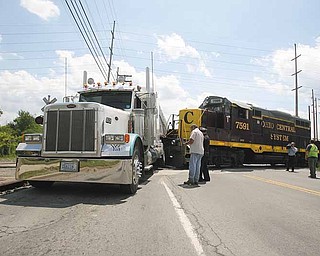 A train hit a tractor-trailer broadside Tuesday afternoon at a crossing at Meridian Road near Vestal Road, blocking the busy intersection for more than 90 minutes. There were no injuries..