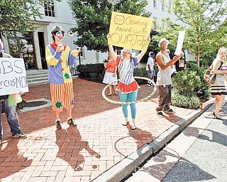 Washington residents, dressed as clowns, take part in a jobs demonstration outside of the Cannon House Office Building on Capitol Hill in Washington Wednesday, July 27, 2011.(AP Photo/Jose Luis Magana)