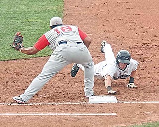 Scrappers baserunner Cody Elliott dives back to first base as Lowell’s Boss Moanaroa waits on a throw during the Scrappers’ 5-3 win at Eastwood Field.