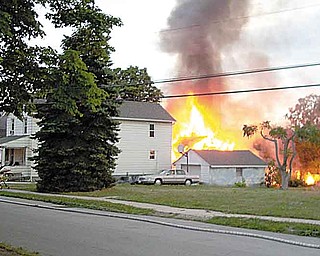 Flames shoot into the air at 118 Lizzie St. in Girard. It was the second of two fires at adjacent, vacant houses this week. Authorities call them “suspicious.”