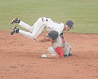 Mahoning Valley’s KC Serna is upended by Lowell’s Travis Shaw during a New York-Penn League game Thursday at Eastwood Field in Niles. The Scrappers fell to the Spinners, 10-7.