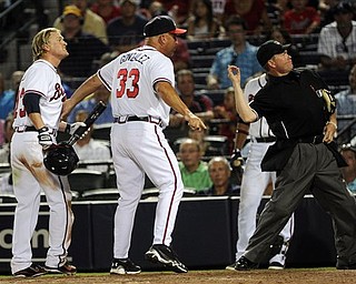 Atlanta Braves manager Fredi Gonzalez (33) is ejected by home plate umpire Jerry Meals after arguing the ejection of Nate McLouth, left, after McLouth argued a strike out during the ninth inning of a baseball game against the Pittsburgh Pirates, Tuesday, July 26, 2011. in Atlanta. (AP Photo/John Amis)