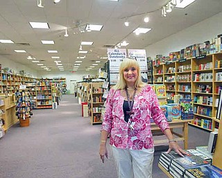 ROBERT K. YOSAY | THE VINDICATOR..Maya Estes - store manager with her lateste arrivals - Borders may be closing, but some independent book stores are thriving, like Bradleys, which recently opened up its first Ohio location in Southern Park Mall. . ..-30-