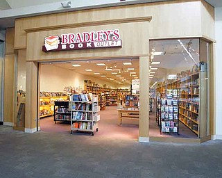 ROBERT K. YOSAY | THE VINDICATOR..Maya Estes - store manager with her lateste arrivals - Borders may be closing, but some independent book stores are thriving, like Bradleys, which recently opened up its first Ohio location in Southern Park Mall. . ..-30-