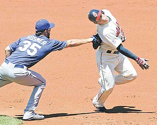 Kansas City Royals first baseman Eric Hosmer, left, tags out Cleveland Indians’ Asdrubal Cabrera in the second inning in a baseball game on Sunday in Cleveland. The Royals won 5-3.