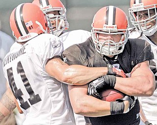 Cleveland Browns running back Peyton Hillis, right, is stopped by cornerback Raymond Ventrone during practice at the NFL football team's training camp Monday, Aug. 1, 2011, in Berea, Ohio. (AP Photo/Tony Dejak)