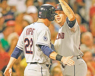 Cleveland Indians' Asdurbal Cabrera, right, celebrates his two-run home run with Jason Kipnis during the eighth inning of a baseball game against the Boston Red Sox at Fenway Park in Boston, Monday, Aug. 1, 2011. Umpires reviewed the drive to right field on video replay to to confirm it was a home run. (AP Photo/Charles Krupa)