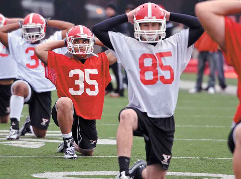 Jamaine Cook (35), stretches during the first practice of Youngstown State’s spring football practice at
Stambaugh Stadium. Cook, sophomore Nick Liste and offensive lineman Dan Radakovich, were named to the Missouri Valley Football Conference preseason all-conference team Monday.