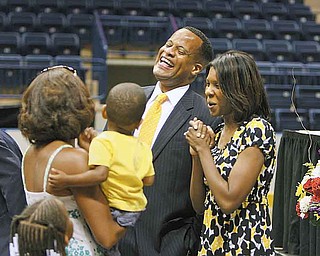 Jay Williams, who resigned Monday as Youngstown mayor, shares a laugh with his wife, Sonja, and Brigitte Brantley of Boardman, who is holding her 17-month-old son, Gary III. Williams had an event at the Covelli Centre to thank the community for its support.