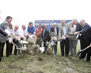 Ohio Gov. John Kasich, seventh from left in blue shirt, helps business, political and development leaders break ground for Solon-based Anderson-Dubose Inc.’s new distribution center in Lordstown.  Dubose  is building a 
$30 million, 155,000-square-foot facility at the Ohio Commerce Center in Lordstown that will bring 160 jobs to the Mahoning Valley. Anderson-Dubose is a McDonald’s supplier. The ceremonial ground breaking was Tuesday.