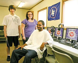 Jason Kessler, left, Tracie Finnie and Jevon Fitzgerald share their experiences as students of Falcon Pride Online. Kessler and Fitzgerald are two students of 11 that graduated from the internet school and received diplomas from Austintown Fitch High School. Finnie will return to the school this year as a junior.