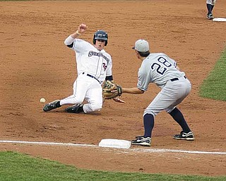 Mahoning Valley Scrappers’ Jordan Smith slides safely into third base as Casey Stevenson of Staten Island waits on the throw Tuesday night in Niles. The Yankess won, 7-4.