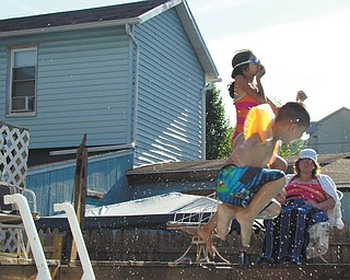 Owen of East Liverpool, left, and Miriam Messiah of Pittsburgh enjoy antics in the pool while Rita Testani of Sharon, Pa., watches. Photo submitted by Gretchen Testani.