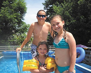 Alivia Horvath, front, Nicholas Workman and Madison Horvath, all of New Middletown, take a break from swimming. Photo sent in by Melanie Workman.