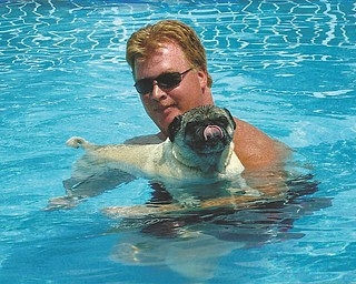 This is one hot dog who knows how to stay cool. Hocheez, a 10-year-old pug, takes a dip in the pool with owner Jeffrey Johnson of Poland.