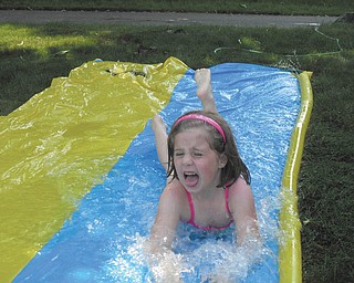 McKenna Sweeney, 6 1/2, of Boardman takes a slippery ride on her Slip & Slide. Photo sent in by Marnee Sweeney.