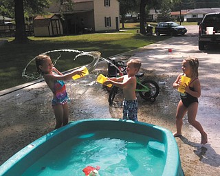 Brelyn, 6, goes up against twins Hadyn and Kaelyn, 4, in a fun water fight. They are the children of Brandon and Jackie Bower of Austintown, who sent in the photo.