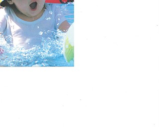 Aiden Rowbotham, 1, looks as though he's yelling, "Woohoooo!" as he enjoys a splash of summer fun.
