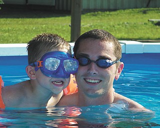 Landon Malmfeldt, 4, enjoys some pool time with Ronnie Malmfeldt in Youngstown.