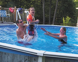 Landon Malmfeldt, 4, enjoys some pool time with Ronnie Malmfeldt and Samantha Hamilton in Youngstown.