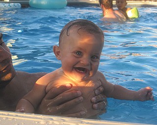 Jacob Hagerty, 6 months, of Boardman, gets some help taking a dip in Grandma and Papa's pool for his Bubba's 84th birthday party. Photo submitted by Nicole Hagerty.