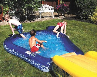 Ray Lillo, front, and Preston and Hailey Piersant of Austintown have fun on the waterslide at their grandma's house.