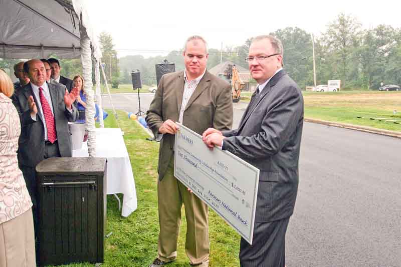 John Gulas, president and CEO of Farmers National Banc Corp. presented a $2,000 donation to Dave Lewis for the Howland Community Scholarship Foundation in memory of Annie Lee. Annie was struck by a vehicle Aug. 16, 2004, at U.S. Route 422 and North Road in Niles, leaving her a quadriplegic. She died in 2006. She was 13.