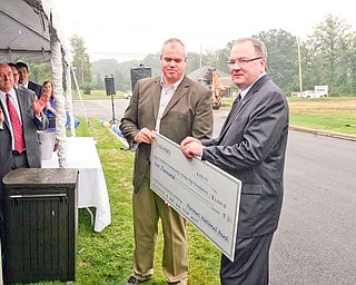 John Gulas, president and CEO of Farmers National Banc Corp. presented a $2,000 donation to Dave Lewis for the Howland Community Scholarship Foundation in memory of Annie Lee. Annie was struck by a vehicle Aug. 16, 2004, at U.S. Route 422 and North Road in Niles, leaving her a quadriplegic. She died in 2006. She was 13.