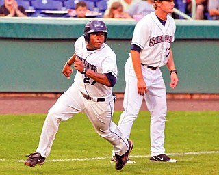 Scrappers baserunner Bryson Myles rounds third base to score as third base coach Dave Wallace watches at Eastwood Field.