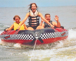 Erin Deak of Lakewood makes waves while tubing on Lake Erie with her parents, Lori and Gary Broderick of Boardman. Photo submitted by Lori Broderick.