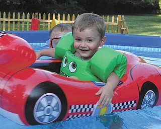 Two-year-old Jimmy Putko of Boardman loves his pool, swimming and cruising in his "Lightning McQueen Car." Photo submitted by Jim and Casey Putko.