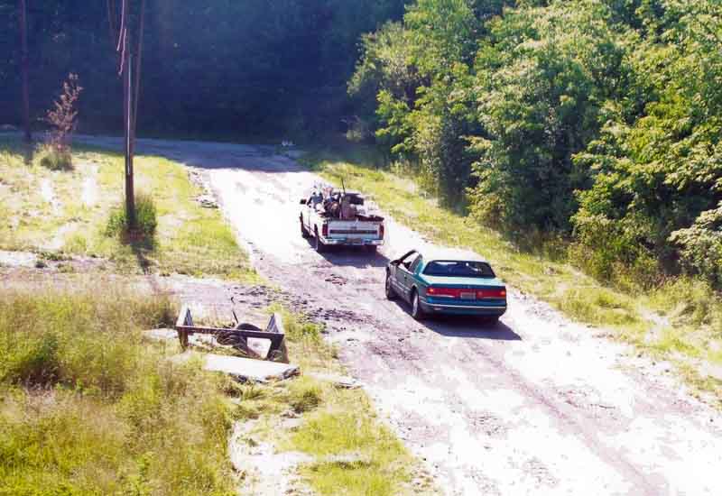 One of Youngstown’s illegal-dumping cameras shows a pickup and a car traveling on the East Side. The truck is carrying wood that the camera later would show being dumped on the side of the street.
