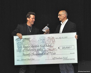 Dunham does a good deed: Ventriloquist and comedian Jeff Dunham presents a $20,000 check to Michael Iberis, executive director of Second Harvest Food Bank of the Mahoning Valley, after Dunham’s July 13 show at the Covelli Centre in Youngstown. The gift will enable the food bank to distribute $300,000 worth of food to hungry people in Columbiana, Mahoning and Trumbull counties.