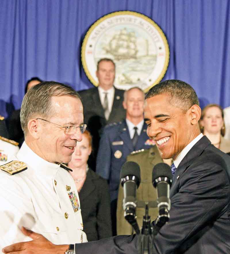 President Barack Obama is greeted by Joint Chiefs Chairman Adm. Mike Mullen, at the Washington Navy Yard in Washington, Friday, Aug. 5, 2011, prior to speaking about efforts to prepare veterans for the workforce. (AP Photo/Carolyn Kaster)