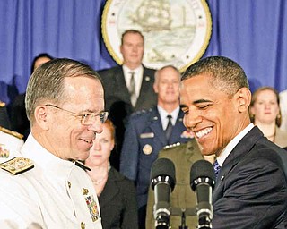 President Barack Obama is greeted by Joint Chiefs Chairman Adm. Mike Mullen, at the Washington Navy Yard in Washington, Friday, Aug. 5, 2011, prior to speaking about efforts to prepare veterans for the workforce. (AP Photo/Carolyn Kaster)