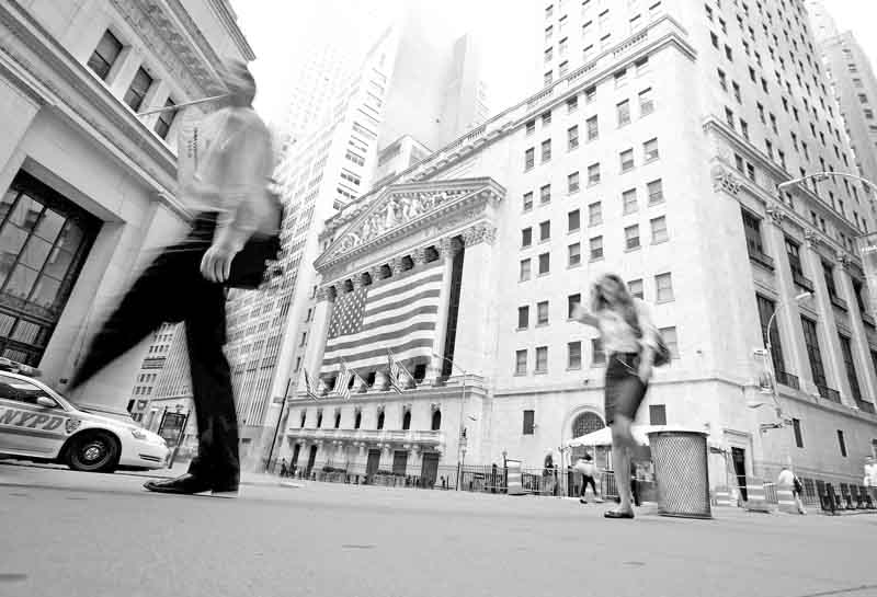 Pedestrians walk past the New York Stock Exchange on Friday, Aug. 5, 2011 in New York. Fears that the economy might dip back into recession helped send the Dow Jones industrial average down 513 points on Thursday. European leaders are struggling to contain that region's debt problems, prompting comparisons to the 2008 financial crisis. Markets tumbled from Tokyo to London Friday as overseas traders reacted to the selloff. (AP Photo/Jin Lee)