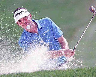 Keegan Bradley hits from the sand to the ninth green during the second round of the Bridgestone Invitational golf tournament at Firestone Country Club in Akron on Friday. Bradley stands at 8-under par in a four-way tie for
the lead.