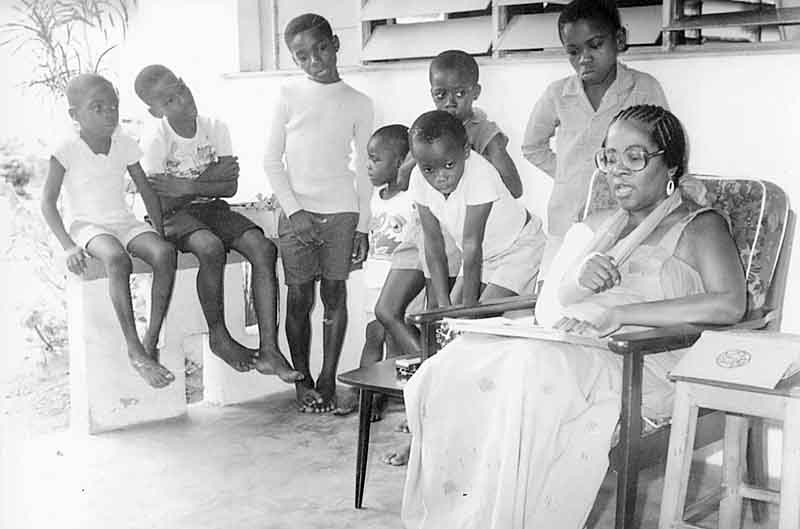 THEN: Chukwuma Anyanwu leans toward Martha Bruce during a story session in Nigeria in the 1970s. Bruce, a former educator in Youngstown, spent years in Nigeria working with young people. She now lives in Sharon, Pa.