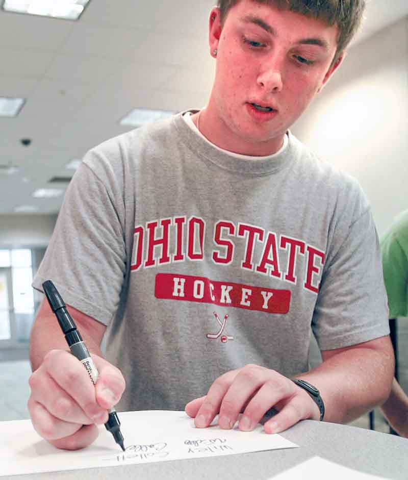 Wiley Collett of Troy, Ohio, a Youngstown State University sophomore, shows how he prints and 
cursively writes his name.