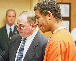 Delord Green, 18, right, looks over the charges against him with his lawyer, Paul Conn, in Youngstown Municipal Court. Green waived his preliminary ruling Monday for his alleged role in the death of Braylen Collins, 17, on July 29.

