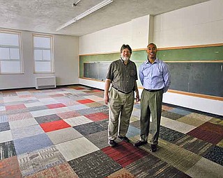 Standing in one of the freshly painted classrooms for the new Science, Technology, Engineering, Arts and Math school on Youngstown’s East Side are John Grahovac, left, school chief administrative officer, and Melvin Brown, regional vice president for Mosaica’s Ohio schools. The school will occupy the former Immaculate Conception School building on Oak Street.