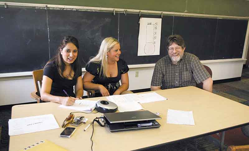 Going over curriculum with John Grahovac, are, from left, Cindy Bova, a first-grade teacher, and Kristine Italiano, head of curriculum. The school opens Aug. 22 and has 14 students enrolled thus far.