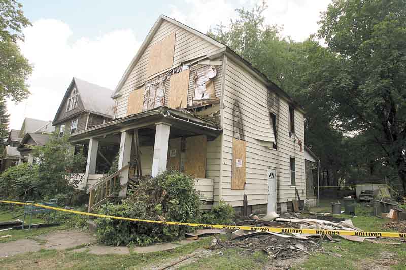 Officials are investigating the cause of the 123 E. Chalmers Ave. fire that killed 83-year-old Patricia Conway. Her son Hilbert Taylor survived TuesdayÕs fire and was taken to an Akron hospital..