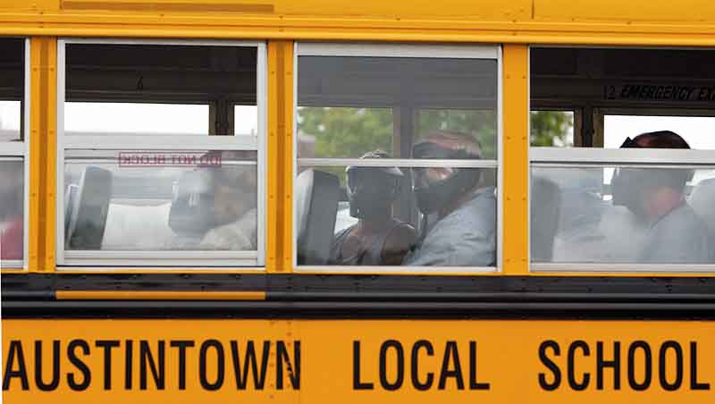 Wearing protective gear, area bus drivers sit in the bus, during a mock crisis drill at Austintown Fitch High School, waiting to witness what would happen if an intruder got onto the vehicle.