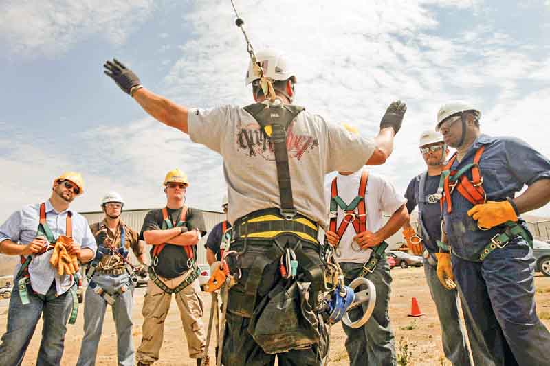 2011 Airstreams is a Tehachapi, California, company that offers safety and rescue courses for wind turbine, oil and gas employees. Students train on a 30-foot mobile tower outside the company's headquarters. Instructor Carl Mosby talks to the students, most of whom are military veterans, about their next exercise: repelling from the tower. (Michael Robinson Chavez/Los Angeles Times/MCT)