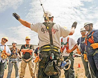2011 Airstreams is a Tehachapi, California, company that offers safety and rescue courses for wind turbine, oil and gas employees. Students train on a 30-foot mobile tower outside the company's headquarters. Instructor Carl Mosby talks to the students, most of whom are military veterans, about their next exercise: repelling from the tower. (Michael Robinson Chavez/Los Angeles Times/MCT)