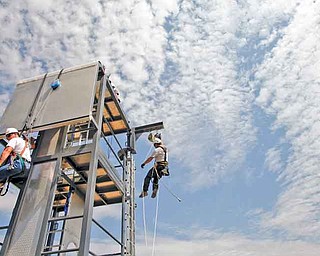 2011 Airstreams is a Tehachapi, California, company that offers safety and rescue courses for wind turbine, oil and gas employees. Students train on a 30-foot mobile tower outside the company's headquarters. Instructor Carl Mosby hangs from the training tower, right, in an exercise designed to train students in repelling techniques. (Michael Robinson Chavez/Los Angeles Times/MCT)