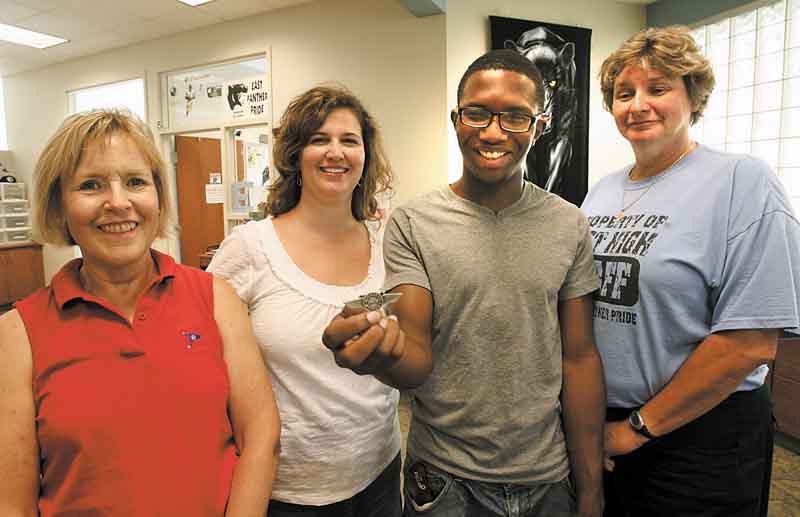 Steven Russ, 17, a senior at East High School, shows off the wings he got from attending Space Camp in Huntsville, Ala. He’s surrounded by East faculty members, from left, Sally Tod Dutton, guidance counselor; Jennifer Walker, English teacher, and Principal Holly Seimetz, whom he calls his angels. The women made Steven’s week at the camp a reality.