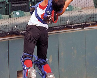 Jenna Schetler, catcher for the Poland 13-14 Junior League Softball All-Stars, tries for a foul ball in the top of the third inning during the Central Region championship game Wednesday against Michigan at Akron’s Firestone Stadium. The Poland team, which represented Ohio, was defeated 3-2.