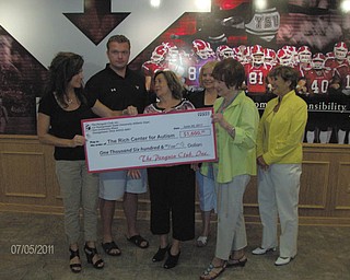 Dr. Melinda Wolford, left, and her husband, Eric Wolford, Youngstown State University head football coach, present a check for $1,600 to officials of the Rich Center for Autism, including, right from center, Phyllis Ricchiuti, board president; Georgia Backus, director; Geri Kosar, founding member; and Juli Costas, board member. The funds were raised through the second annual Women’s Football Clinic at YSU’s Stadium Club in May, organized by Dr. Wolford, Dan Kopp, Coach Carmen Bricillo and Lynn Cadle. The event aims to inform local women about the game while raising funds for area charities. It included dinner, a tour of Stambaugh Stadium and demonstrations by coaches on game strategies and regulations. Last year’s proceeds went to breast-cancer research, but the coaches wanted the funds to stay in the YSU community this year, so they chose the Rich Center, which has operated on the campus since 1995 and currently serves 70 families.